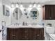 Charming bathroom featuring dual sinks, decorative mirrors, and stylish fixtures for a luxurious feel at 6100 Bahia Del Mar Cir # 105, St Petersburg, FL 33715