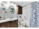 Well-lit bathroom featuring a classic vanity, built-in storage, and a shower with a decorative curtain at 6100 Bahia Del Mar Cir # 105, St Petersburg, FL 33715