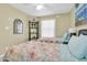 Comfortable bedroom featuring twin beds with floral comforters, a ceiling fan, and natural light at 6100 Bahia Del Mar Cir # 105, St Petersburg, FL 33715