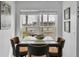 Bright dining area with a glass top table and seating for four; waterfront views at 6100 Bahia Del Mar Cir # 105, St Petersburg, FL 33715