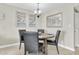 Cozy dining area with table set for four, features beach-themed art at 6100 Bahia Del Mar Cir # 105, St Petersburg, FL 33715