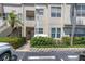 A closer view of the condo's facade, showing the entrance and landscaping at 6100 Bahia Del Mar Cir # 105, St Petersburg, FL 33715