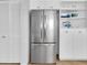 Modern stainless steel refrigerator with white cabinets and shelving at 6100 Bahia Del Mar Cir # 105, St Petersburg, FL 33715