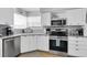 Clean kitchen with stainless steel appliances, white cabinets, and granite countertops at 6100 Bahia Del Mar Cir # 105, St Petersburg, FL 33715