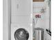 Efficient laundry area with a stacked washer and dryer, plus shelving for laundry supplies at 6100 Bahia Del Mar Cir # 105, St Petersburg, FL 33715