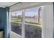 Scenic view from a window overlooking a pond and lush landscaping, creating a serene atmosphere at 6100 Bahia Del Mar Cir # 105, St Petersburg, FL 33715
