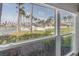 Scenic view from a window overlooking a pool and lush landscaping, creating a serene atmosphere at 6100 Bahia Del Mar Cir # 105, St Petersburg, FL 33715