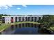 A tranquil waterfront building offers scenic views of the surrounding lake and greenery at 6190 80Th N St # 102, St Petersburg, FL 33709