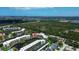 Aerial view featuring lush greenery and a pond highlighting the community and surrounding areas at 6190 80Th N St # 102, St Petersburg, FL 33709