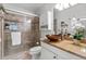 Updated bathroom featuring glass shower, stone tile, and unique copper bowl sink at 6190 80Th N St # 102, St Petersburg, FL 33709
