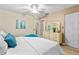 Comfortable bedroom featuring a ceiling fan, a dresser, and a queen-size bed with bright blue accents at 6190 80Th N St # 102, St Petersburg, FL 33709