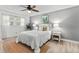 This stylish bedroom is bright and airy with a ceiling fan, rug, and bedside lamps at 6190 80Th N St # 102, St Petersburg, FL 33709