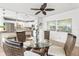 Inviting dining area with a glass table, wicker chairs, stylish ceiling fan, and views of kitchen at 6190 80Th N St # 102, St Petersburg, FL 33709