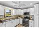 Charming kitchen featuring white cabinets, stainless steel appliances, and ample counter space at 6190 80Th N St # 102, St Petersburg, FL 33709