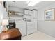 This laundry room features a washer, dryer, shelving, and storage, making chores a breeze at 6190 80Th N St # 102, St Petersburg, FL 33709