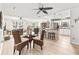 Bright living room featuring a ceiling fan, open-concept layout, and smooth flooring for a warm ambiance at 6190 80Th N St # 102, St Petersburg, FL 33709
