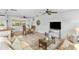 Cozy living room featuring smooth flooring, a ceiling fan, neutral tones, and an open-concept layout at 6190 80Th N St # 102, St Petersburg, FL 33709