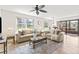Bright living room with large windows, neutral decor, and an adjacent dining area at 6190 80Th N St # 102, St Petersburg, FL 33709
