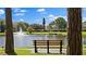 Relaxing bench view overlooking a serene pond with a fountain and well-maintained landscaping at 6190 80Th N St # 102, St Petersburg, FL 33709