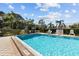 Inviting outdoor swimming pool surrounded by lush greenery, lounge chairs, and clear blue water at 6190 80Th N St # 102, St Petersburg, FL 33709