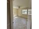 Cozy bedroom featuring tile floors and natural light through two windows at 650 Palm Pl, Safety Harbor, FL 34695