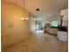 Eat-in kitchen with tile floors, white cabinetry, and sliding glass door to the backyard at 650 Palm Pl, Safety Harbor, FL 34695