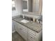Bathroom featuring granite countertops with storage cabinets, a mirror and a neutral color palette at 7524 Oakshire Dr, Port Richey, FL 34668