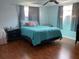 Bright bedroom with ceiling fan, wood flooring, and windows at 7524 Oakshire Dr, Port Richey, FL 34668