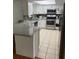 Bright kitchen featuring white cabinets, stainless steel appliances, granite countertops, and tile flooring at 7524 Oakshire Dr, Port Richey, FL 34668
