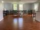 Spacious living room with hardwood floors, natural light, and neutral decor creating a welcoming atmosphere at 7524 Oakshire Dr, Port Richey, FL 34668