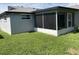 View of home's screened-in porch, perfect for outdoor relaxation and entertaining at 7524 Oakshire Dr, Port Richey, FL 34668