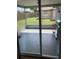 View from inside the screened porch, with backyard view and outdoor grill at 7524 Oakshire Dr, Port Richey, FL 34668