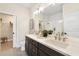 Bathroom featuring double sinks, quartz countertops, and a glass-enclosed shower at 7798 93Rd N St # 1, Seminole, FL 33777