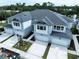 New townhomes featuring multiple garage doors, stone accents, and professionally landscaped grounds at 7798 93Rd N St # 1, Seminole, FL 33777