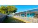 Spacious screened-in patio with an in-ground swimming pool and a view of the blue exterior home at 821 Karen St, Palm Harbor, FL 34684