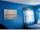 Inviting bedroom with bright blue walls and sheer curtains for a serene atmosphere at 821 Karen St, Palm Harbor, FL 34684