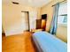 Cozy bedroom featuring a single bed, large window, and convenient closet space, creating a functional retreat at 821 Karen St, Palm Harbor, FL 34684