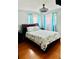Bright and airy bedroom with large windows, a queen bed, and stylish coastal-themed decor at 821 Karen St, Palm Harbor, FL 34684