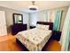 Cozy bedroom with a queen bed, dresser, and soothing wall color, creating a relaxing retreat at 821 Karen St, Palm Harbor, FL 34684