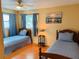 Charming bedroom with two twin beds, a ceiling fan, and a warm, inviting ambiance at 821 Karen St, Palm Harbor, FL 34684