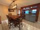 Inviting dining room with stylish lighting and an open view into the well-appointed kitchen at 821 Karen St, Palm Harbor, FL 34684