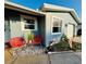 Charming home exterior with vibrant red patio chairs and well-maintained landscaping at 821 Karen St, Palm Harbor, FL 34684