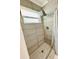 Contemporary tiled shower stall showcasing modern shower head and convenient window for natural light at 821 Karen St, Palm Harbor, FL 34684