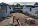 Backyard with a paved area, bench, bench, and gray siding of adjacent structures at 8503 N Willow Ave, Tampa, FL 33604
