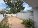 Backyard featuring a patio with stone pavers, a metal shed, and an overgrown garden at 8503 N Willow Ave, Tampa, FL 33604