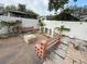 Backyard featuring a stone fire pit and surrounding seating areas at 8503 N Willow Ave, Tampa, FL 33604