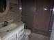 Bathroom with a glass shower and a oval-shaped mirror above the sink at 8503 N Willow Ave, Tampa, FL 33604