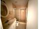Bathroom with a toilet, shower and a oval-shaped mirror above the sink at 8503 N Willow Ave, Tampa, FL 33604