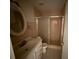 Cozy bathroom featuring a tile shower, ornate vanity, and oval mirror at 8503 N Willow Ave, Tampa, FL 33604
