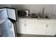 Kitchen featuring stainless steel appliances, white cabinets, and a marble countertop at 8503 N Willow Ave, Tampa, FL 33604